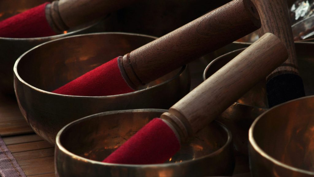 a close up of many metal bowls with wooden handles