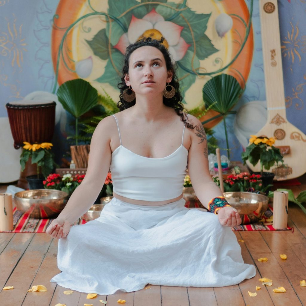 Woman meditating in a room with musical instruments.
