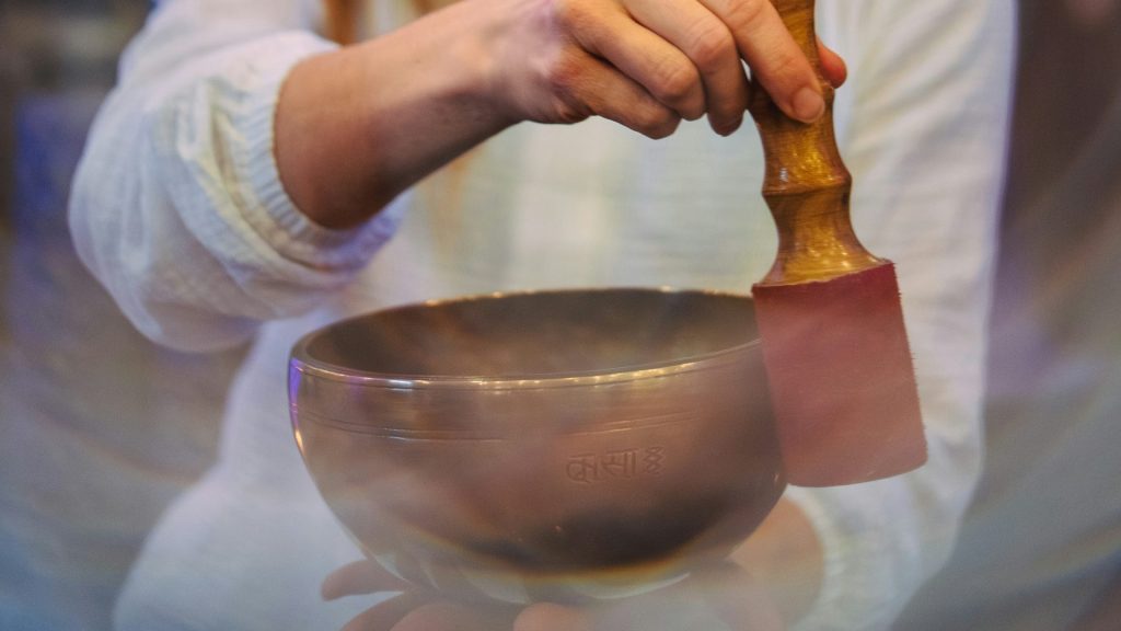 A woman mixing a bowl with a wooden spoon